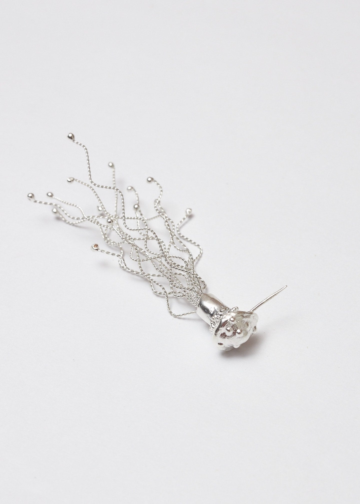 Arete/broche Miscelios plata